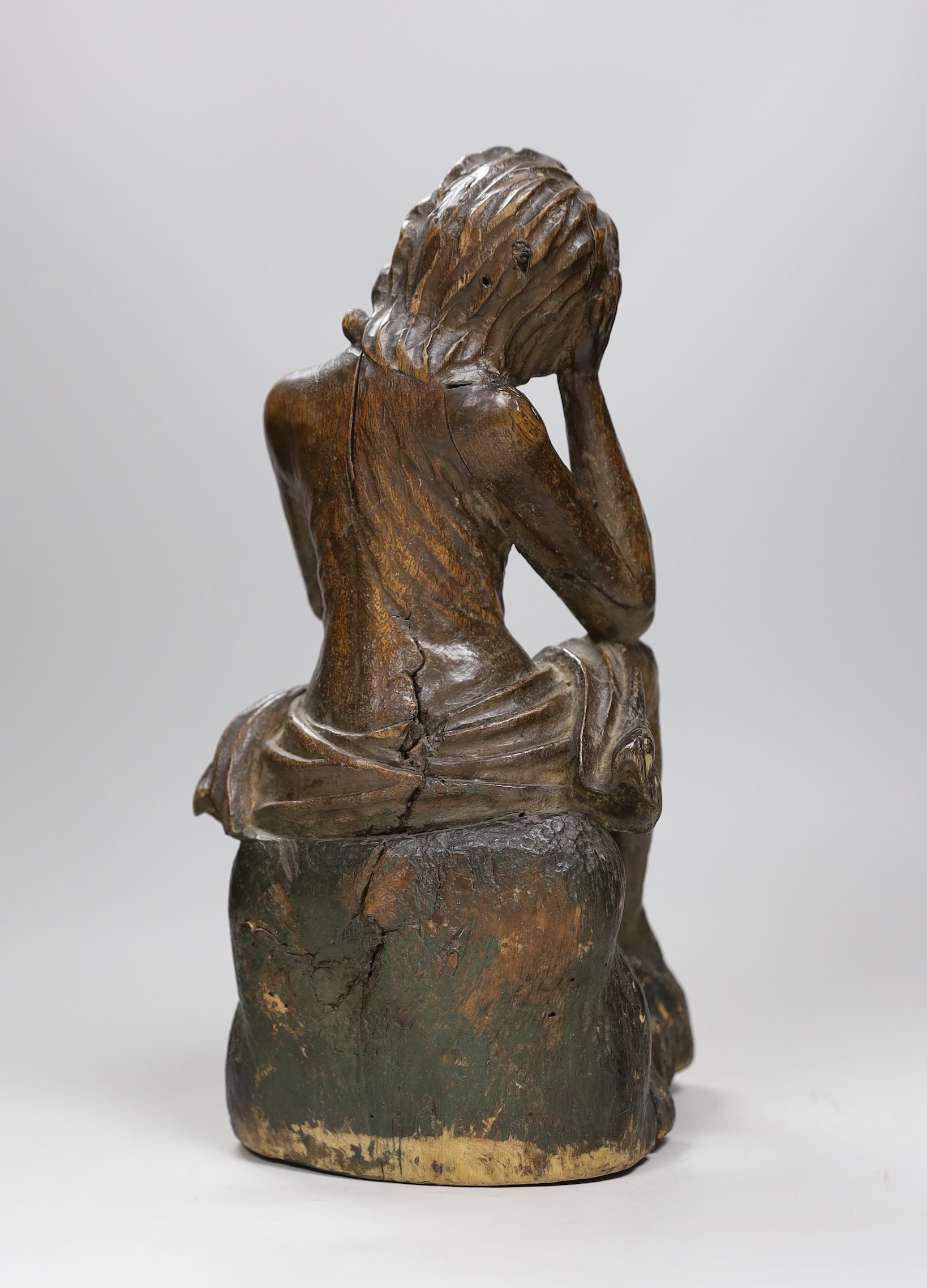 A 17th/18th century Italian limewood figural carving of Jesus perched, 31cm
